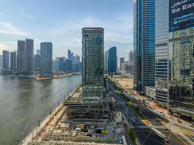 a tall building under construction next to a river at Livin' Holidays - Studio - Close to downtown in Dubai