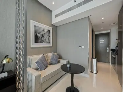 a living room with a couch and a table at Livin' Holidays - Studio - Close to downtown in Dubai