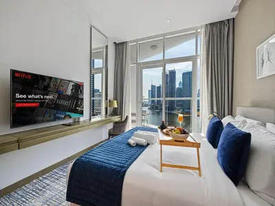 a hotel room with a large bed and a large window at Livin' Holidays - Studio - Close to downtown in Dubai