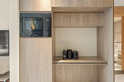 a kitchen with a microwave and two microwaves at Stylish studio Near Downtown Dubai with Pool & Gym Access in Dubai