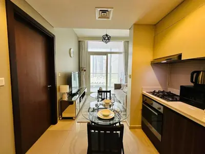 a small kitchen with a glass table in a room at Elite & Classy Furnished and Exquisite Living Room in Dubai