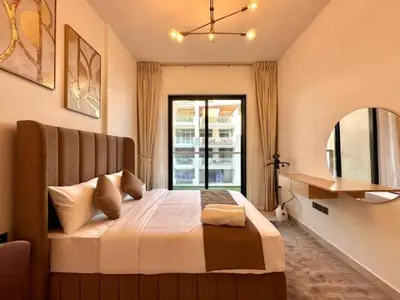 a bedroom with a large bed with a window at Exclusive Retreat and Spacious Unit in JVC in Dubai