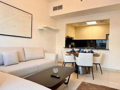 a living room with a couch and a table at Exclusive Retreat and Spacious Unit in JVC in Dubai