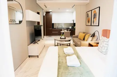 a living room with a couch and a table at Luxury Studio l Rooftop Pool & Gym Access in Dubai