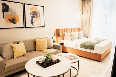a living room with a bed and a couch at Luxury Studio l Rooftop Pool & Gym Access in Dubai