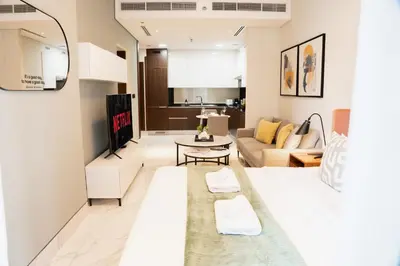 a living room with a couch and a table at Luxury Studio l Rooftop Pool & Gym Access in Dubai