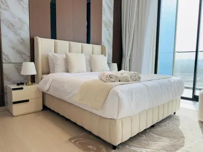 a bedroom with a large bed with towels on it at Brand New with Installed Private Pool in Balcony in Dubai