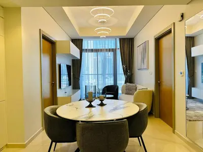 a dining room with a table and chairs at Cozy Haven High Rise Balcony and Upscale Furnished in Dubai