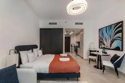 a bedroom with a bed and a living room at Modern Studio at Paragon with City View in Dubai