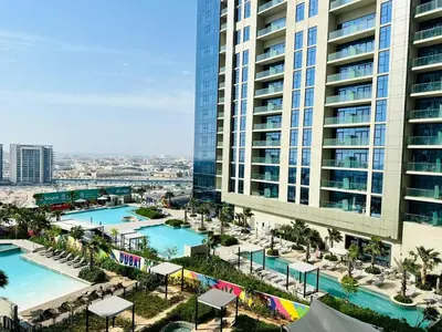 an aerial view of a resort with two swimming pools at Sleek Charm Inviting Atmosphere and Cozy Balcony in Dubai