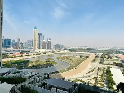 a view of a city with a river and buildings at Sleek Charm Inviting Atmosphere and Cozy Balcony in Dubai
