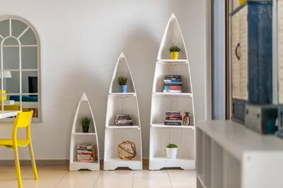 a room with white shelves with potted plants on them at Spacious 2BR Flat with Gym & Pool in JBR in Dubai
