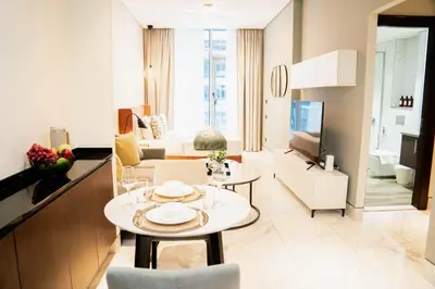 a living room with a table and a living room at Modern Studio in Business Bay l Pool, Gym & Sauna in Dubai