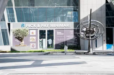 a building with a sign that reads pick pay min implement at Modern Studio in Business Bay l Pool, Gym & Sauna in Dubai