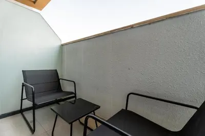 a chair and a table in a room at GuestReady - Chic & modern studio in Dubai in Dubai