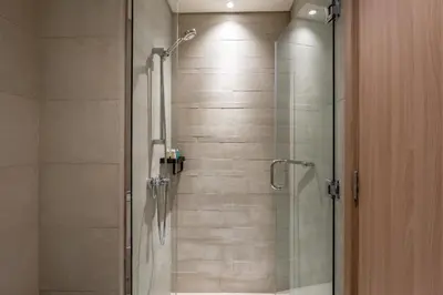 a bathroom with a shower with a glass door at GuestReady - Chic & modern studio in Dubai in Dubai