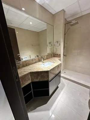 a bathroom with a sink and a large mirror at Stay Inn AlBarsha by PHM in Sabkhah