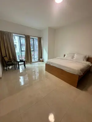 a bedroom with a bed and a chair in it at Stay Inn AlBarsha by PHM in Sabkhah