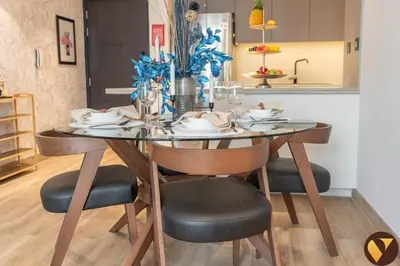 a dining room table with chairs and a dining room table at Vogue JVC Chaimaa Avenue near Circle Mall, One Bedroom Apartment with Balcony and City View, Access to all Amenities in Dubai
