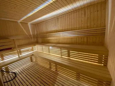 a large wooden sauna with a bench in it at Vogue JVC Chaimaa Avenue near Circle Mall, One Bedroom Apartment with Balcony and City View, Access to all Amenities in Dubai