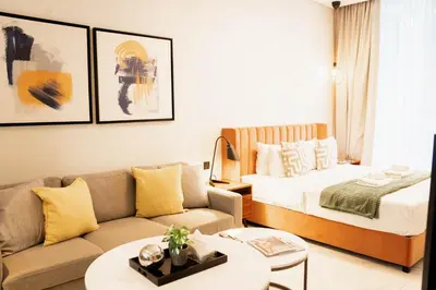 a living room with a bed and a couch at Chic Business Bay Retreat l Pool, Luxury Amenities in Dubai