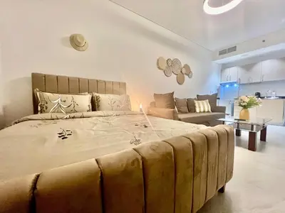 a bedroom with a large bed and a couch at Karama stunning unit for 4 in Dubai
