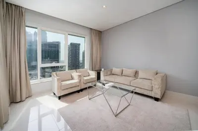 a living room with two couches and a glass table at Chic Business Bay 1Bed Retreat with Canal Views in Dubai