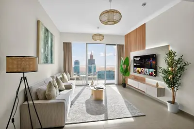 a living room with a couch and a tv at Downtown Luxury - 4 Minutes Walk to Dubai Mall & Burj Khalifa in Dubai