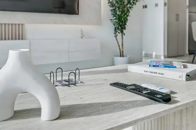 a kitchen counter with a remote control and a vase at Downtown Luxury - 4 Minutes Walk to Dubai Mall & Burj Khalifa in Dubai
