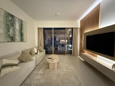 a living room with a couch and a flat screen tv at Downtown Luxury - 4 Minutes Walk to Dubai Mall & Burj Khalifa in Dubai