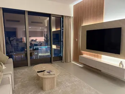 a living room with a large television and a couch at Downtown Luxury - 4 Minutes Walk to Dubai Mall & Burj Khalifa in Dubai
