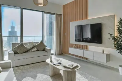 a living room with a couch and a tv at Downtown Luxury - 4 Minutes Walk to Dubai Mall & Burj Khalifa in Dubai