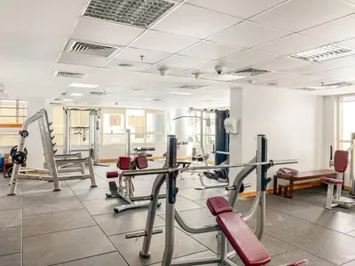 a gym with several treadmills and exercise machines at Elegant 1-Bedroom Apartment in Dubai Marina in Dubai