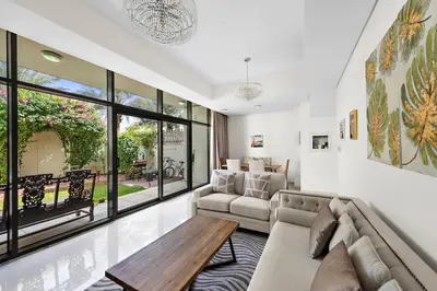 a living room with a couch and a table at Elegant 3BR Villa with Access to Pool & Gym in Dubai