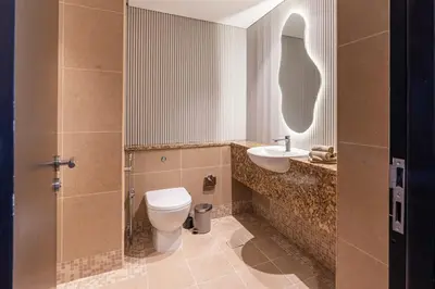 a bathroom with a toilet and a sink at Chic Urban Loft SkyGardens DIFC, Dubai in Dubai