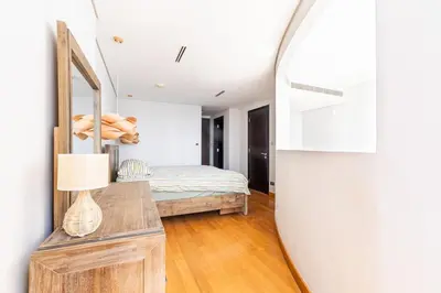 a bedroom with a bed and a mirror at Chic Urban Loft SkyGardens DIFC, Dubai in Dubai