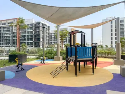 a playground in a city with children playing on it at VayK - Modern 1BR with Spacious Terrace in Dubai