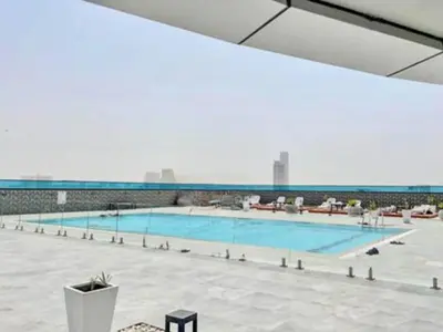 a large swimming pool with a view of the city at Modern Studio with Stunning City Views in Dubai