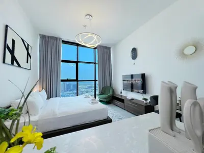 a bedroom with a bed and a large window at Modern Studio with Stunning City Views in Dubai