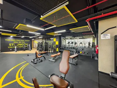 a gym with chairs and equipment in a room at Spacious Studio - 10 min drive to Burj Khalifa in Dubai