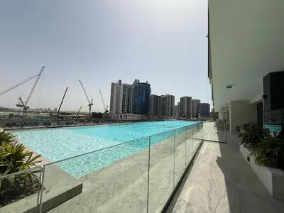 a large swimming pool on the side of a building at Daniels Studio with Private Jacuzzi & Canal View in Dubai