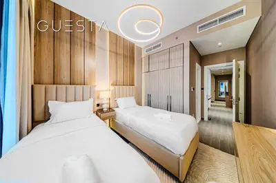 two beds in a hotel room with two beds at Kensington Waters, MBR City, Dubai in Dubai