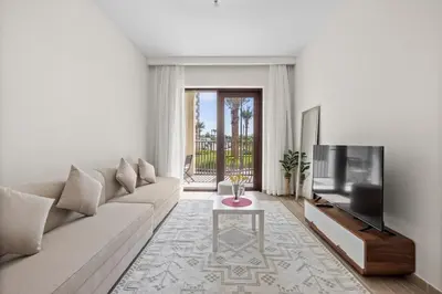 a living room with a couch and a tv at Spacious 1 bedroom in creek beach-Huge Balcony in Dubai