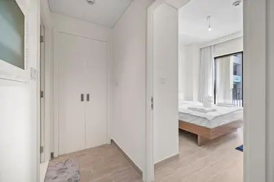a bedroom with white walls and a bed at Spacious 1 bedroom in creek beach-Huge Balcony in Dubai