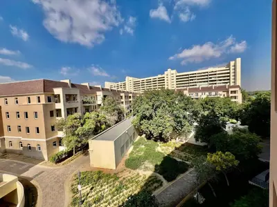 an overhead view of a building with trees in front of it at Motor City Shakespeare Circus in Dubai