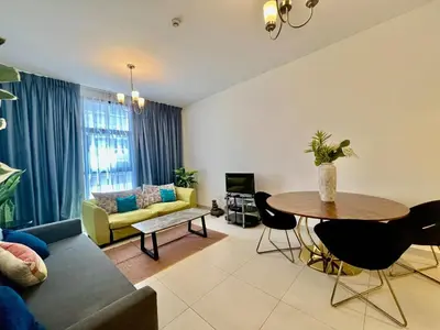 a living room with a couch and a table at Jaddaf Pool Gym Parking in Dubai