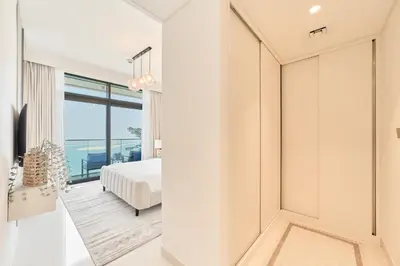 a bedroom with a bed and a view of the ocean at Luxury 2BR in Beach Vista With Stunning Palm Views in Dubai