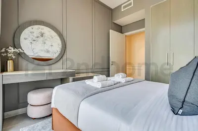 a bedroom with a white bed and a mirror at Burj Khalifa view, 3 Bedroom, Maids Room, Forte in Dubai