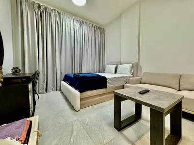 a living room with a bed and a couch at Sleep 3 Walk to ADCB metro in Dubai