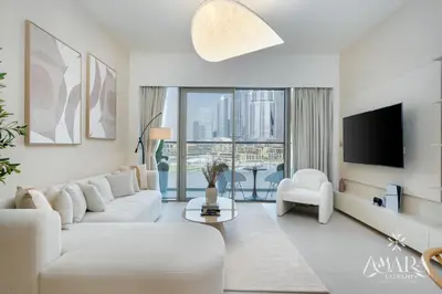 a living room with white furniture and a large window at Grande Luxury, Burj Khalifa & Fountain View in Dubai